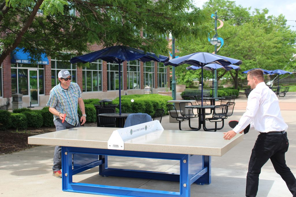 Play table tennis or ping pong outdoors.